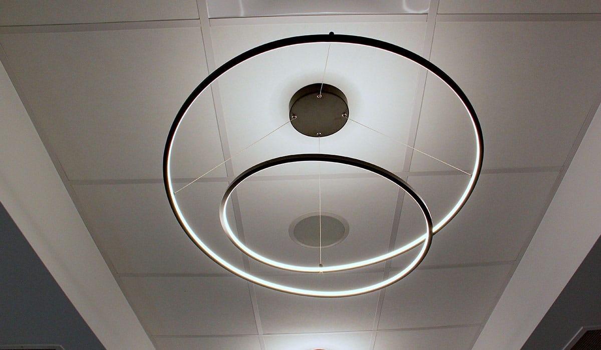 modern spiral shaped decorative light hanging from drop ceiling