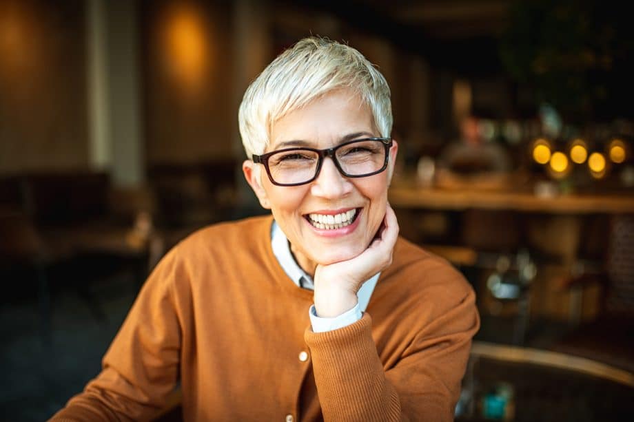 woman with glasses smiling